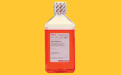 Cell culture buffer bottle on yellow background Cell culture buffer bottle on yellow background