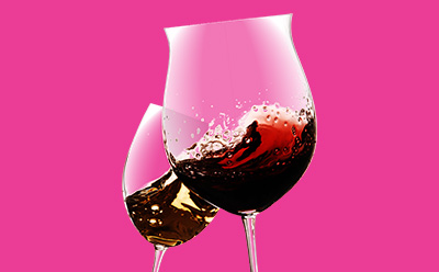Two wine glasses, one filled with red wine and the other with white wine, displaying spoilage testing of wine with bubbles and reflections.