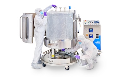 Mobius<sup>®</sup> ADC Reactor Two operators, fully gowned, installing the single-use Ultimus® Bag in the Mobius® ADC reactor