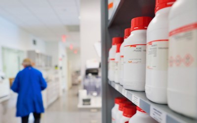 White Bottle Red Cap shelves with red capped bottles in a laboratory setting