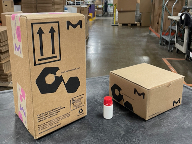 boxes big and small Two boxes are seen in the image. The one on the left is significantly smaller than the box on the right. In the middle a bottle shows that packaging it into the box on the right is much more size appropriate than the left box.