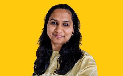 Sakshi Kabra Malpani Sakshi Kabra Malpani headshot on a vibrant yellow background
