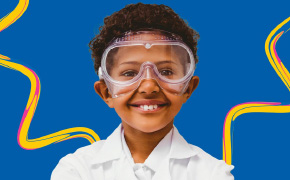 SPARK™ Program Poster A promotional poster for the SPARK™ program featuring a young child dressed in a white lab coat and safety goggles, symbolizing curiosity and scientific exploration. The vibrant blue background includes the text "Curiosity Experiments" and the SPARK™ logo, inviting viewers to engage with hands-on science activities.