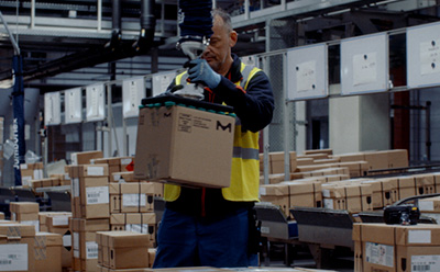 Warehouse Worker Handling Sustainable Packaging