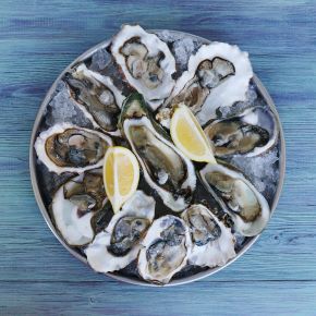 Fresh oysters can accumulate traces of toxic metals High angle view of raw oysters and lemon slices on a plate on a table