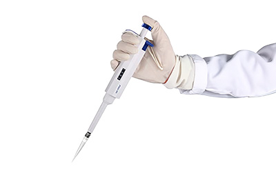 Gloved hand holding pipette to add purified water or PBS to antibody vial. Gloved hand holding pipette to add purified water or PBS to antibody vial.