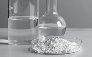 Ultrapure Biochemicals Laboratory glassware and a petri dish containing a white substance.