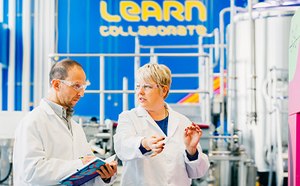 Scientists in the MLab This image shows two scientists in the MLab with bioreactors in the background.