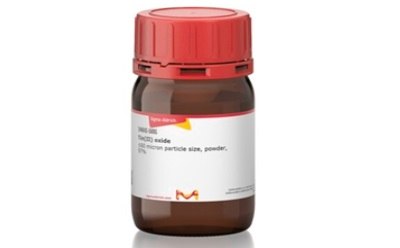 A small brown glass bottle with a red screw cap and a white label. The label includes a yellow arrow pointing right, the Sigma-Aldrich logo, product information stating “Iron(III) oxide ≥99% trace metals basis, fine particle size, powder,” and hazard pictograms indicating the substance is harmful if swallowed and causes skin irritation.
