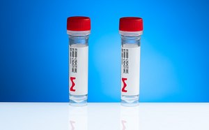 Two laboratory sample vials with red caps