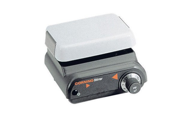 A Corning plate stirrer with a white top and a black base featuring control dials. The device is designed for laboratory use to stir liquids, ensuring consistent mixing for scientific experiments.