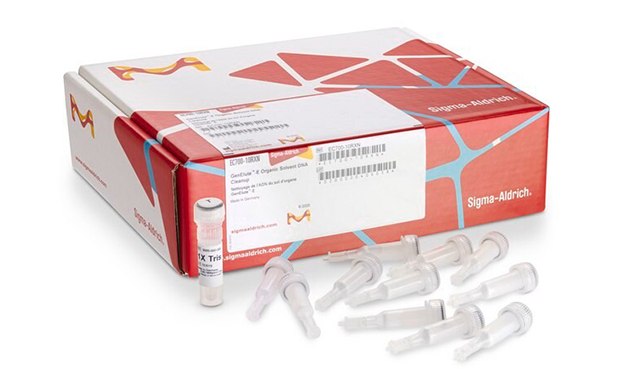 A box from Sigma-Aldrich, with the company’s logo visible on the packaging. In front of the box, there are six individual vials with white caps and clear bodies, arranged in two rows. Three vials are standing upright, and three are lying horizontally in front of an unopened product box which has red and white color scheme with additional labeling partially visible.