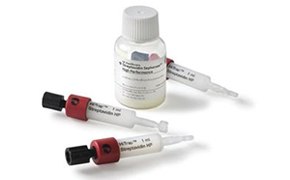 The image features a small white bottle with medication and three HiTrap Protein G HP syringes used for protein purification. The syringes have a white body, red caps, and black plungers. The bottle and syringes have labels with dosage instructions.