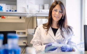 Samaridou lab tile Eleni Samaridou stands in the lab wearing a lab coat, gloves and glasses.