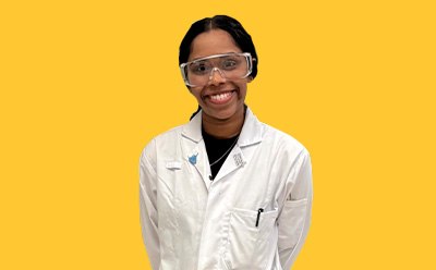 Sakshi Kabra Malpani headshot on a vibrant yellow background