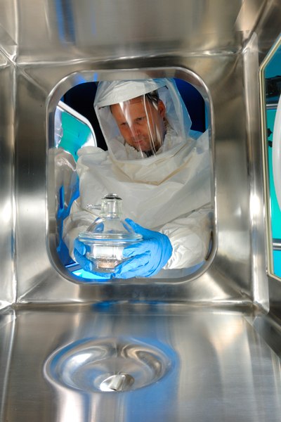 Team member handling highly active compound at contract manufacturing facility