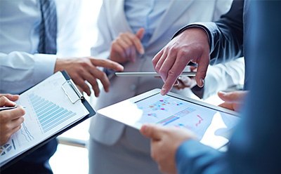 A group of people looking at a tablet