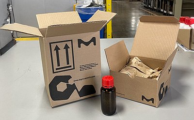 A box next to a smaller box and product bottle, demonstrating reduced packaging size and airspace for efficient shipping. A box next to a smaller box and product bottle, demonstrating reduced packaging size and airspace for efficient shipping.