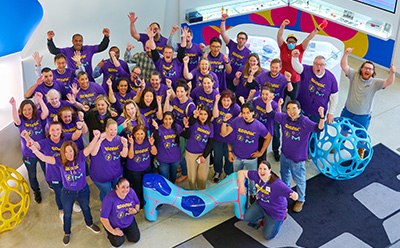 SPARK™ Curiosity Wall A close-up image of a wall covered with hexagonal sticky notes, each featuring handwritten questions and curiosities from children. The notes are in various colors and include phrases like “I’m curious to know…” and questions about germs, the ocean, and other intriguing topics, creating an engaging and interactive learning environment.