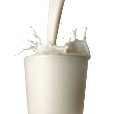 Drinking glass with milk being poured and splashing over the top.