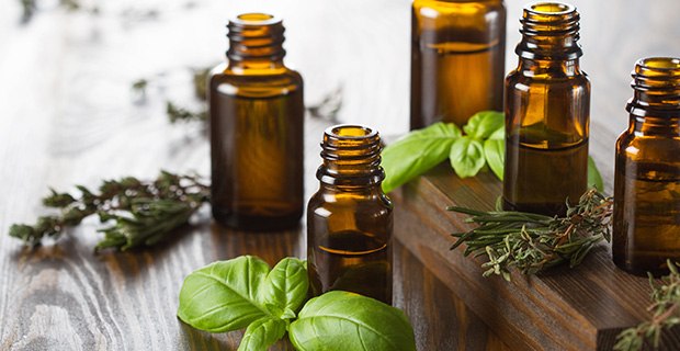 Essential oils bottles with herbs